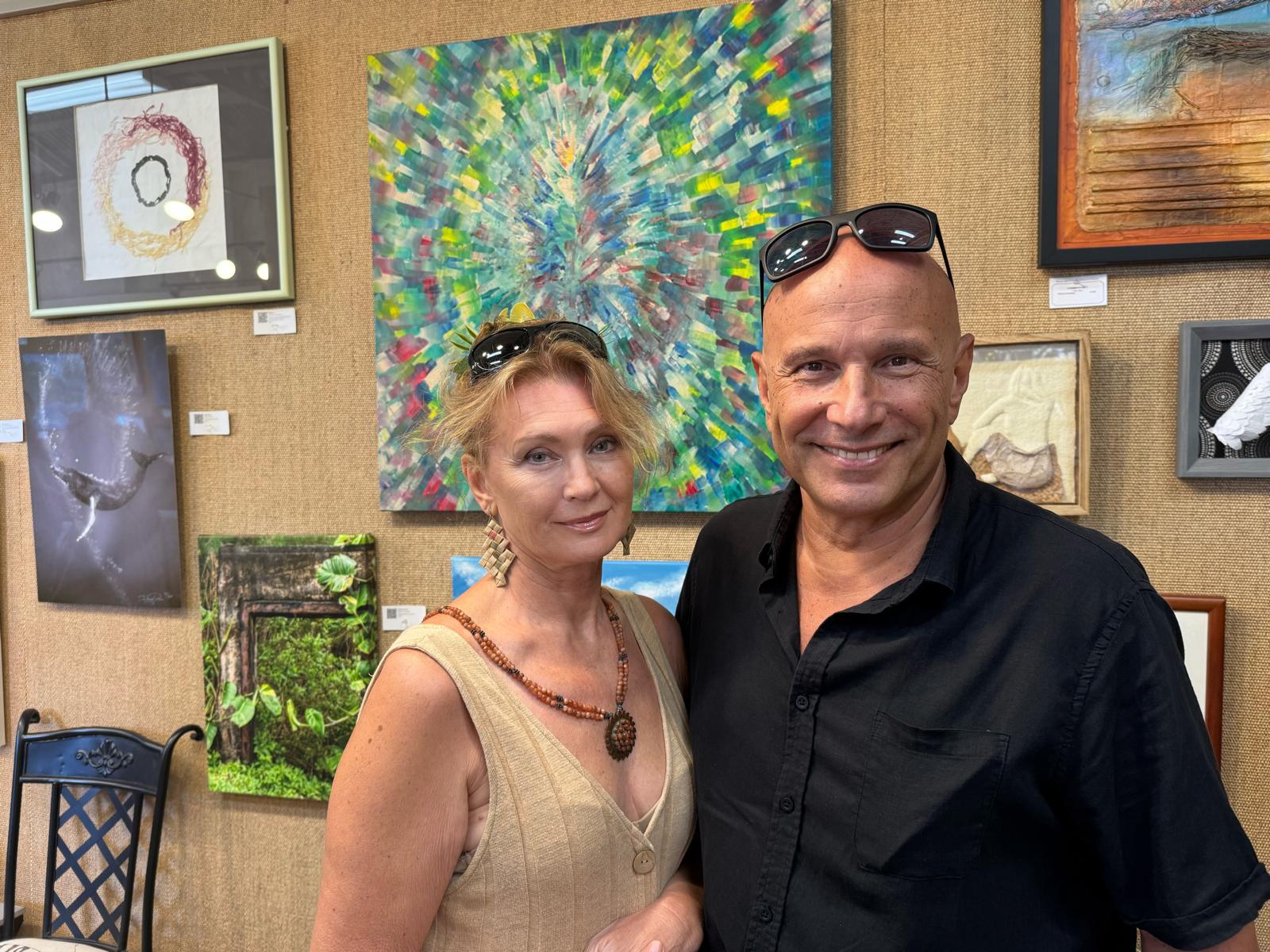 Sasha Chichagov with his wife Lena Nevsky in front of the painting Source